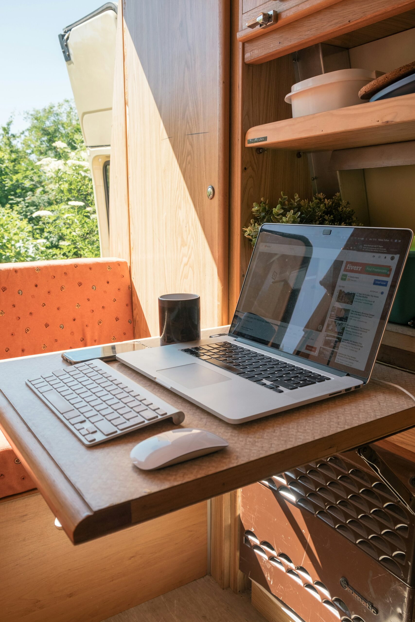 A fully tech system setup with a coffee cup. A new trend page is open on laptop also.